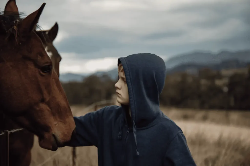 adolescent patting therapy horses in paddock
